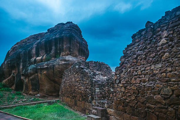 istock Ancient stone walkway between large rock formations in Badami, Karnataka. The rugged texture of the natural landscape highlights the region's historical and geological importance 2224248726