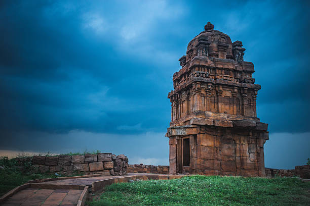 Ancient sandstone temple tower at Badami, Karnataka, India, under a dramatic sky.