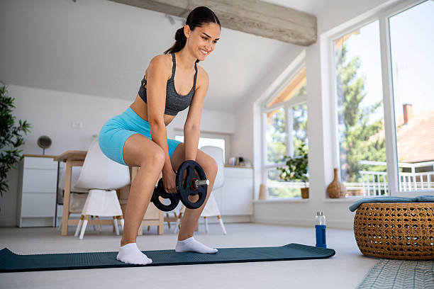 istock Young woman working out at home 2224249644