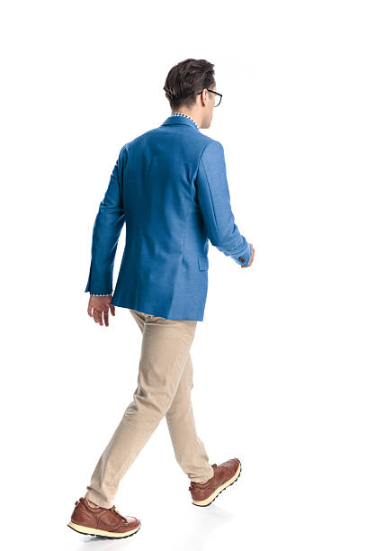 istock behind view of casual young man with glasses walking on white background 2224250144