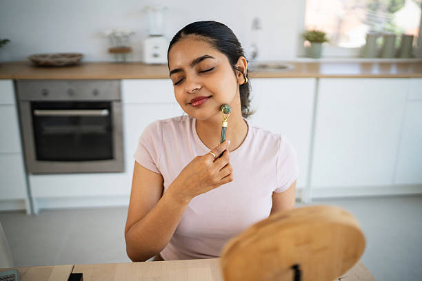 istock Young Indian woman massages her face with a jade roller 2224251888