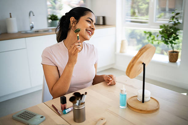 istock Young Indian woman massages her face with a jade roller 2224252063