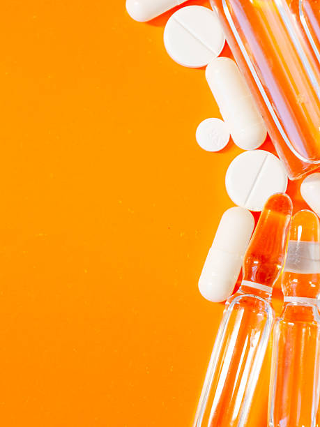 istock Pharmaceutical preparations and medications of various shapes and sizes, including tablets, capsules, and ampoules, are arranged on a bright orange background. 2224255361