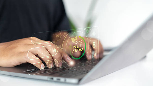 istock Businessman working on laptop with digital interface showing net zero 2050 sustainability goals, renewable energy, and carbon neutral initiatives for green technology and environmental innovation. 2224257372
