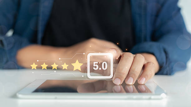 istock Customer giving a five-star rating and digital review feedback on a tablet for customer satisfaction, service quality, and online business rating concept. 2224257382