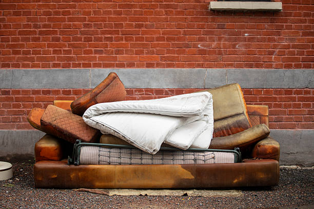 Fly tipped sofa bed on a city street