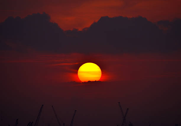 A beautiful sunrise with cloudy sky on the beach in Singapore.