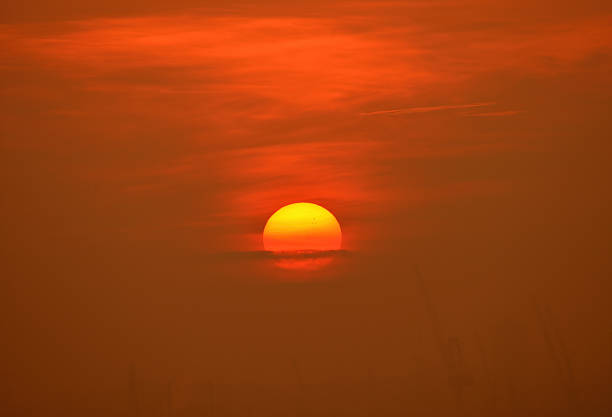 A beautiful sunrise with cloudy sky on the beach in Singapore.