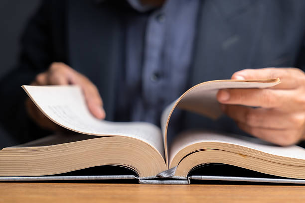 istock Businessman Reading and Searching Information in Book 2224266208