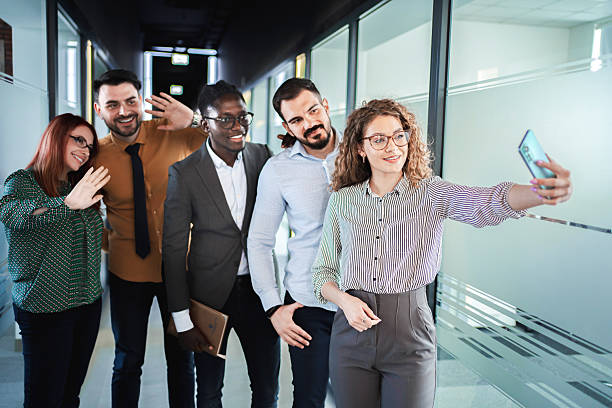 istock Business Team Taking Selfie in Office Hallway 2224267218