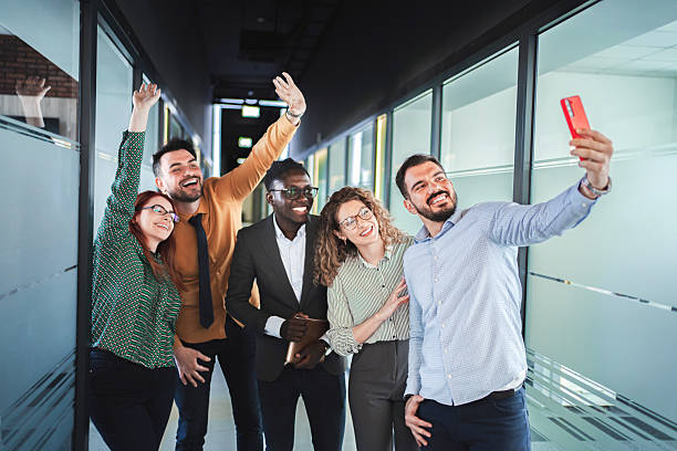 istock Happy business team taking a selfie in the office corridor 2224267230