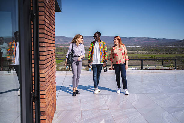 istock Businesspeople walking and talking on a modern building rooftop 2224267286