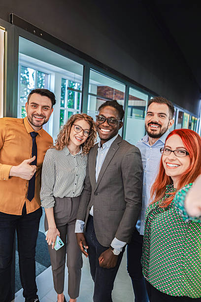 istock Smiling business team taking a selfie in office 2224267326
