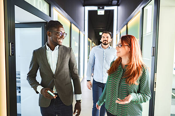 istock Business People Walking and Talking in Office Corridor 2224267385