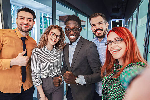 istock Happy business team taking a selfie in the office corridor 2224268469
