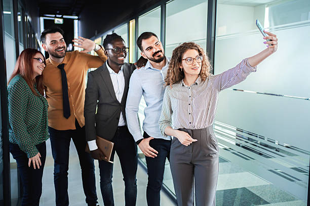 istock Business Team Taking a Selfie in Modern Office Corridor 2224268548
