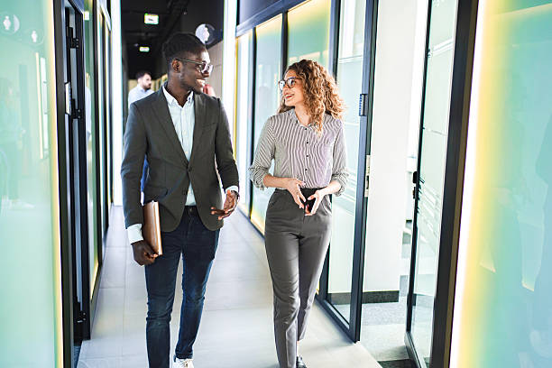 istock Businesspeople walking and talking in office corridor 2224269214