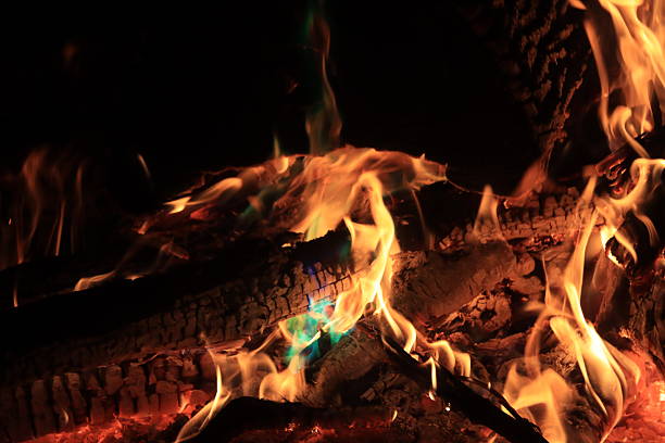 A bonfire with colored flames makes a warm night enjoyable.