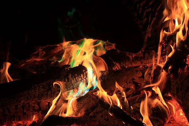 A bonfire with colored flames makes a warm night enjoyable.