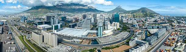 A panoramic aerial view of the Mother City, Cape Town, in South Africa. Table Mountain in background, skyscrapers and Table Bay dock in foreground.