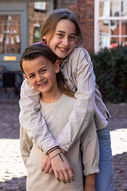 twin girls fancy dressed up pretending be siamese with his father shirt