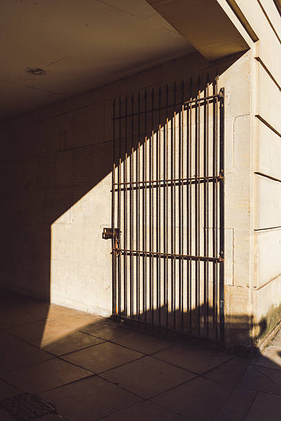 istock Sunlight illuminating a metal gate in a dark underpass in Bath, England 2224272696