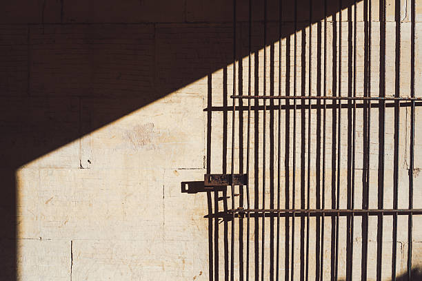 istock Sunlight illuminating a metal gate in a dark underpass in Bath, England 2224272706