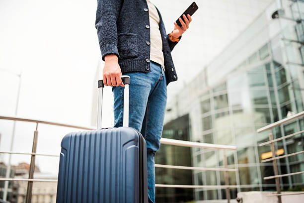 istock Lower section shot of a businessman on a work trip using smart phone. 2224273743
