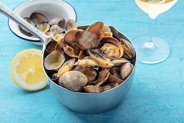 istock Vongole clams in a sauce pan, with lemon and white wine 2224274419