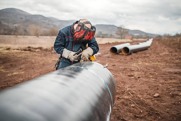 istock A focused welder uses welding equipment while working on a pipeline inspection 2224274619