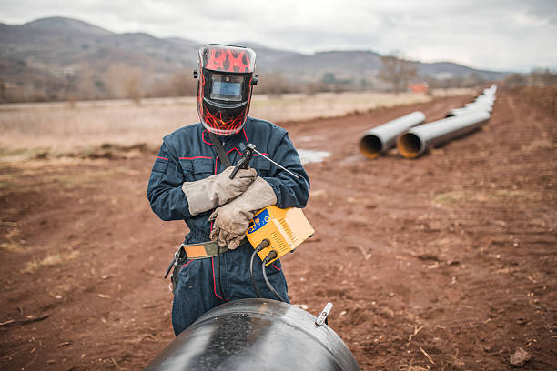 istock A welder uses welding equipment while working on a pipeline inspection 2224274663