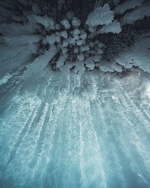 Ice cave with icicles on Baikal lake at sunset. Winter landscape of Baikal lake, Siberia, Russia