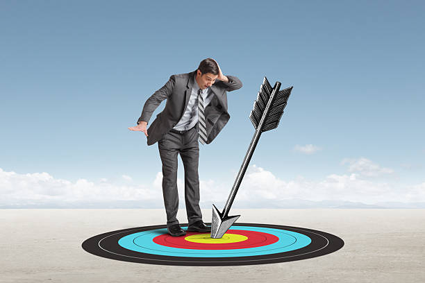 istock Astonished Man Looks Down At  Arrow That Has Hit Its Mark 2224277608