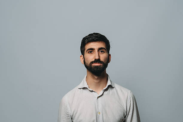 istock Young businessman looking at camera with serious expression 2224278744