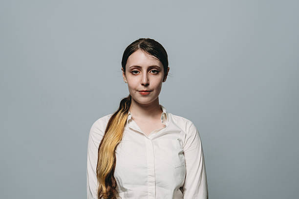 istock Young businesswoman looking at camera with neutral expression, studio portrait on gray background 2224278759