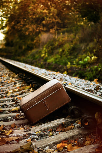 istock Abandoned Old Suitcase On Railroad Tracks At Sunset. 2224278868