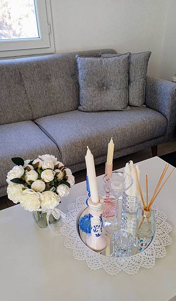 istock Coffee table and sofa set. Fresh white roses and decorative candles in a glass vase. 2224282781