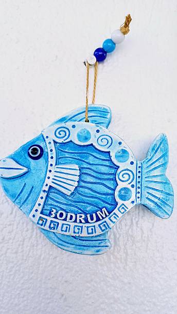 istock Decorative wall hanging with fish figures. Handmade ornament with blue beads. Gift item. 2224283050