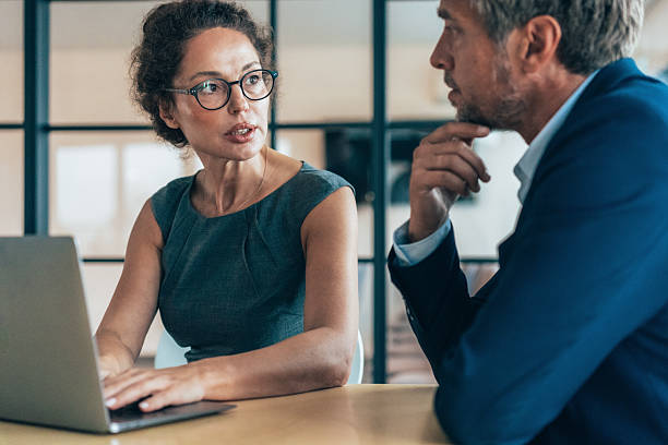 istock Two business coworkers talking 2224284045