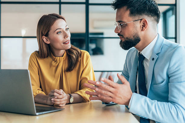 istock Two business coworkers talking 2224284059