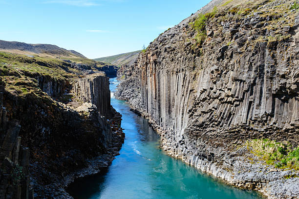 Explore the stunning geometric rock formations of studlagil canyon in iceland
