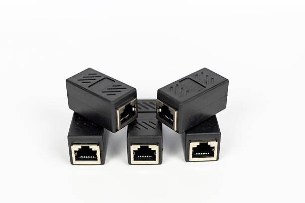 istock Neatly arranged five black RJ45 Ethernet extender connectors on a clean white background. 2224286656