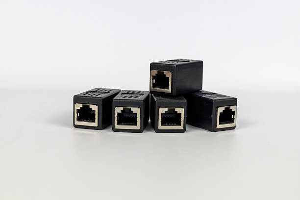 istock Neatly arranged five black RJ45 Ethernet extender connectors on a clean white background. 2224286659