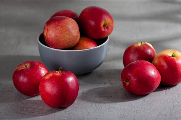 istock Fresh red apples in a bowl on gray surface 2224288544
