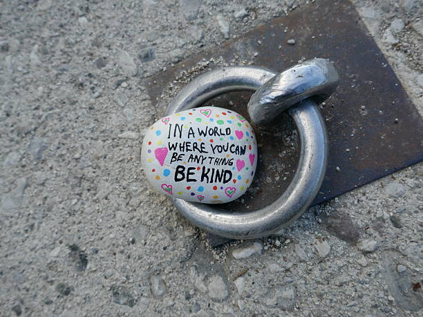 istock Metal ring for securing boat on dock with be kind kindness rock 2224288633