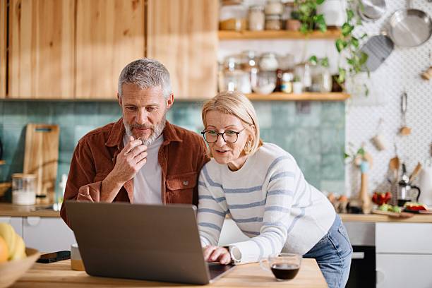 istock Couple in Their 50s Checking Recipes on Laptop in Kitchen 2224289050