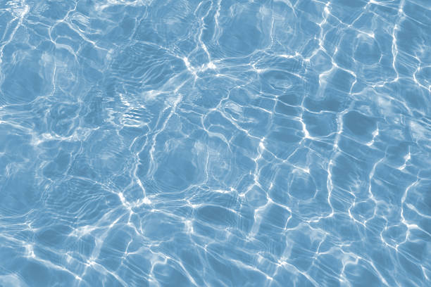 istock Bright water waves and sunlight hitting the water surface. Modern light blue futuristic background 2224289657
