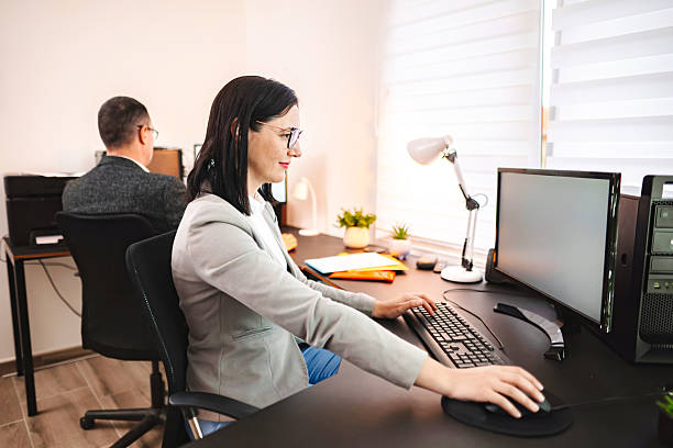 istock Businesswoman concentrating on her work on desktop computer in bright office 2224289760