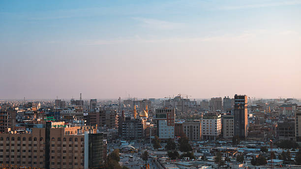 istock Karbala cityscape featuring buildings and golden domes during sunset 2224292808