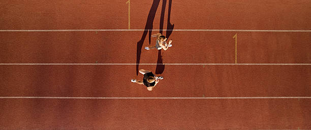 istock Top down view of two runners training on red running track 2224298115